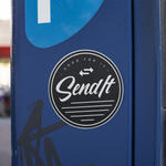 Blue box with 'SendIt' logo on a blurred background