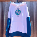 White hoodie with blue sleeves and a logo on a wooden background